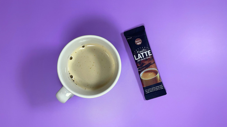 Cafe Tastlé's instant latte packet next to a mug
