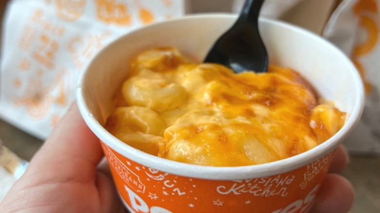 Popeyes mac & cheese cup in a hand