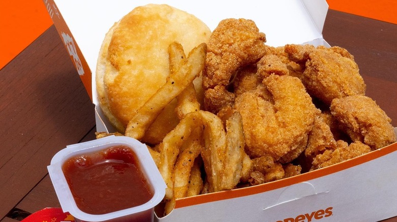 Popeyes popcorn shrimp in a box with other foods