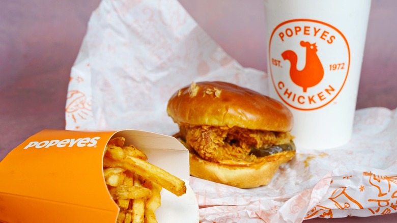 Popeyes fries, chicken sandwich and drink on paper