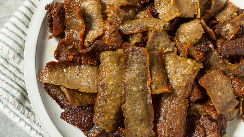 shaved pieces of gyro-style lamb meat sitting in a white dish