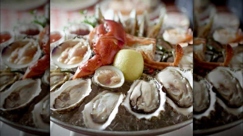 Oysters and lobster with lemon on ice