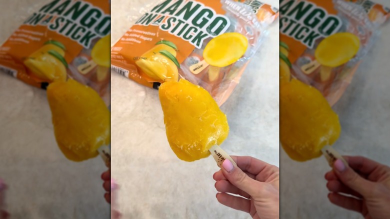 Mango on a stick being held by hand