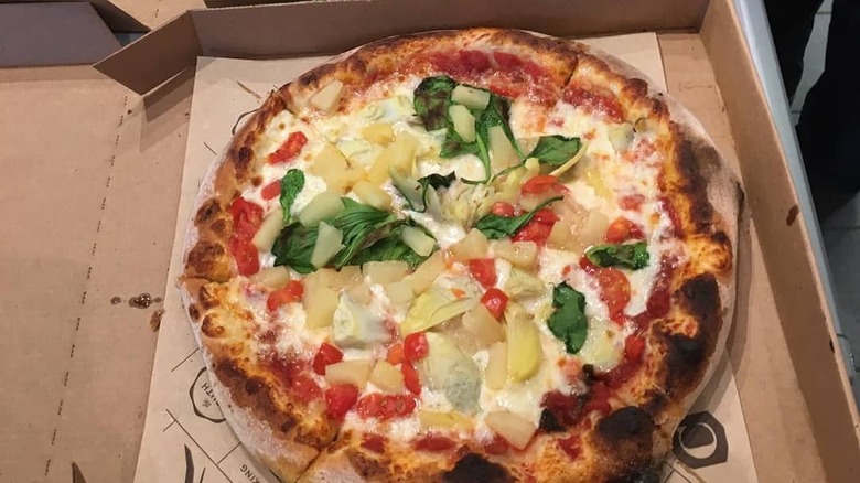 The pizza in a takeaway box from Pizza Cucinova