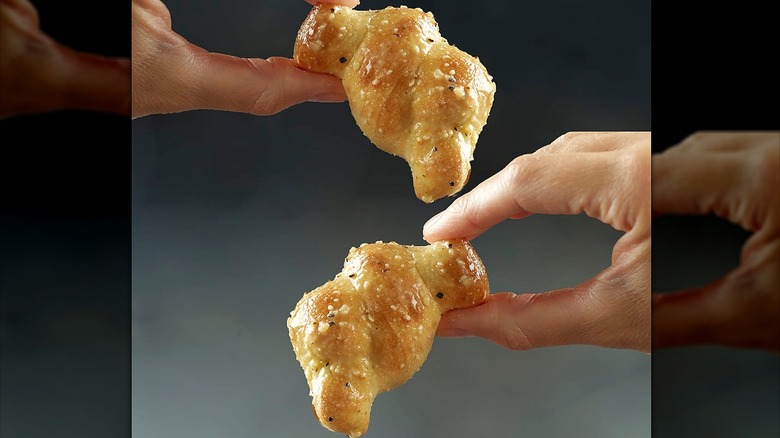 Hand holding garlic knots