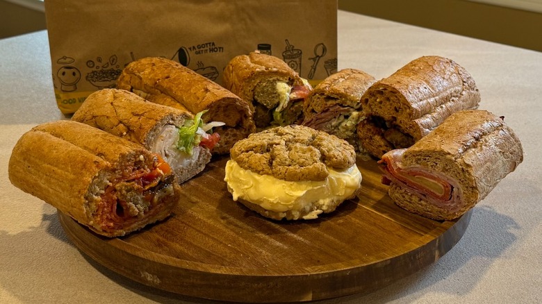 Potbelly sandwiches on a wooden tray on a counter