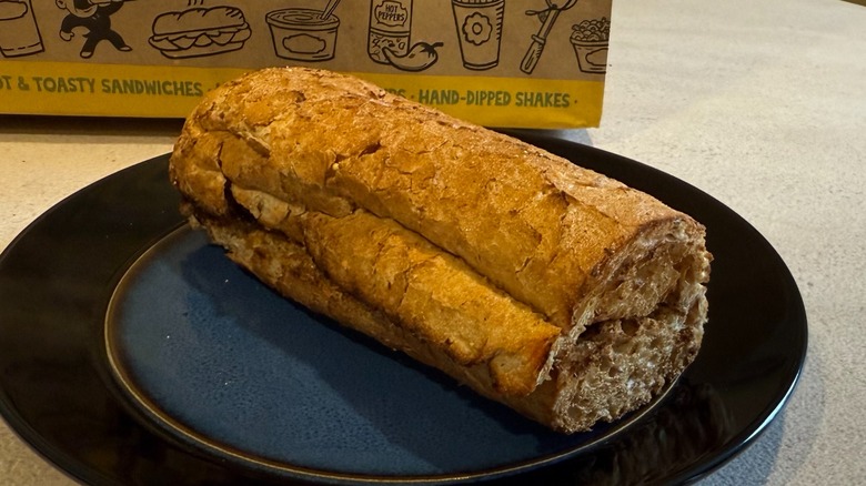 A toasted sandwich on a blue plate