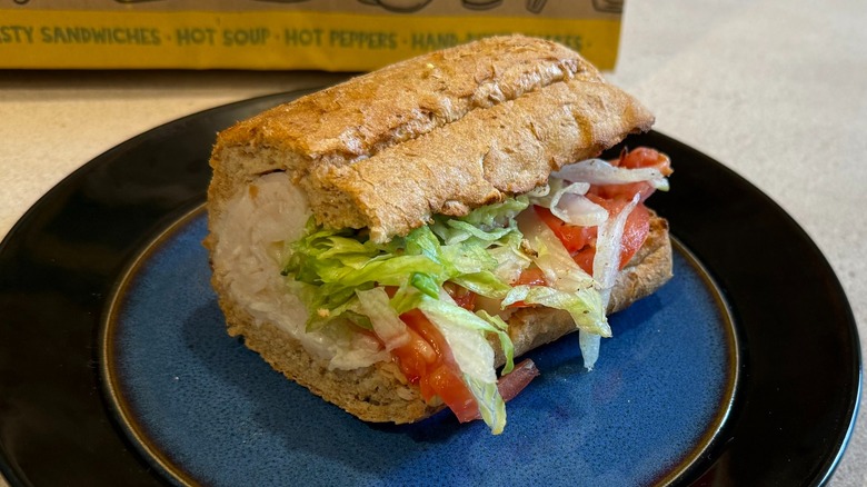 A turkey sandwich with lettuce and tomato
