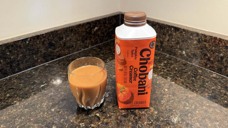 Chobani coffee creamer and glass of coffee on countertop