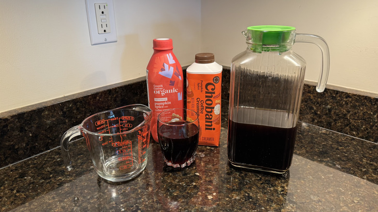 Pumpkin creamers with coffee and glasses