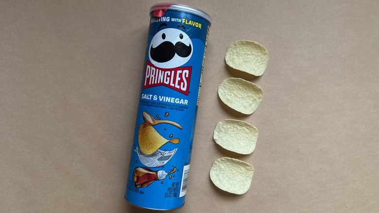 Pringles Salt & Vinegar Chips on brown surface next to canister