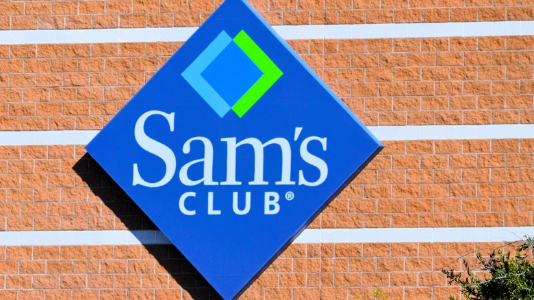 A Sam's Club sign on a brick wall of a warehouse