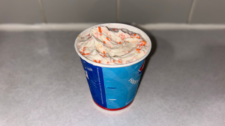 A vanilla Birthday Cake Blizzard with orange sprinkles