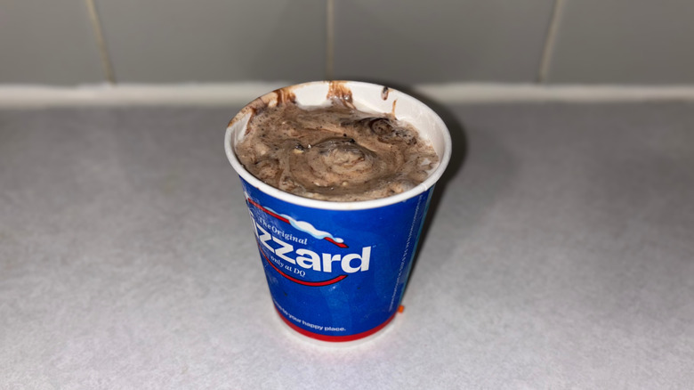 A chocolate-colored blizzard with fudge and peanut butter mixed in
