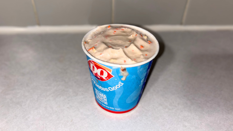 A vanilla blizzard with orange sprinkles mixed in