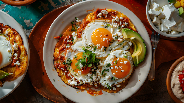 A plate of eggs chilaquiles with spicy salsa.