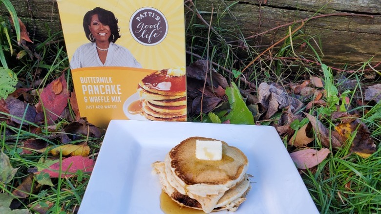 a stack of Patti's Good Life buttermilk pancakes with butter and syrup