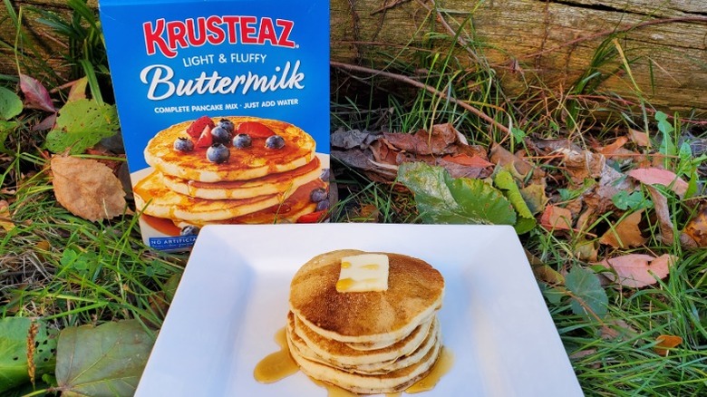 A stack of Krusteaz buttermilk pancakes with butter and syrup