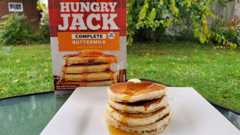 A stack of Hungry Jack buttermilk pancakes with butter and syrup