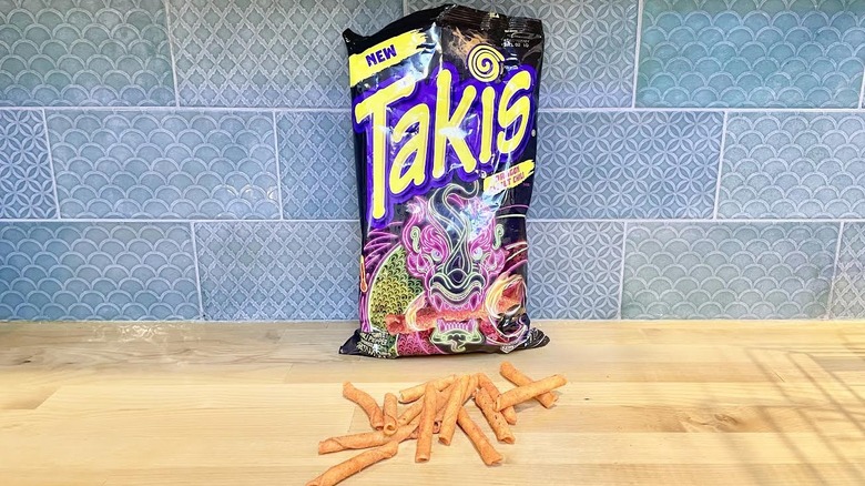 Bag of Takis Dragon Sweet Chili with chips alongside