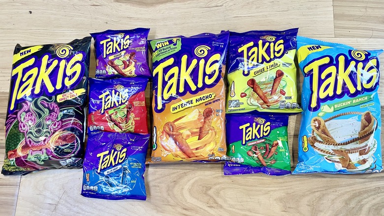 Collection of various Takis on wooden background