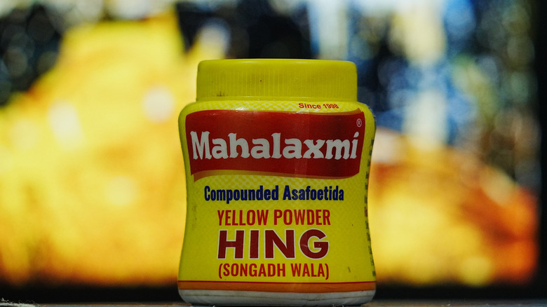 A small yellow container of compounded asafoetida yellow powder Hing