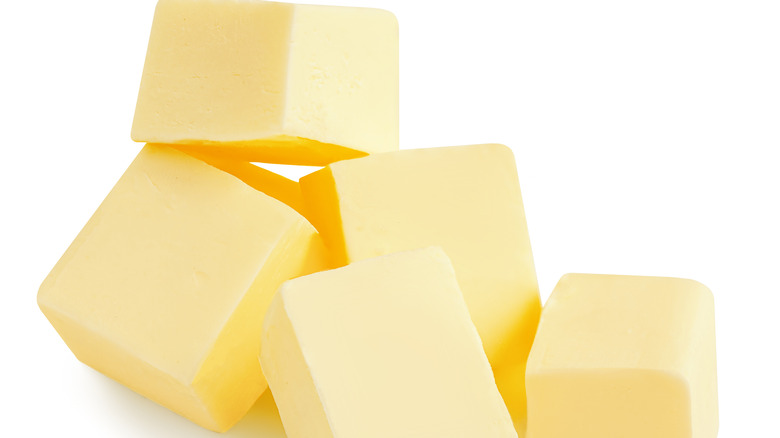 Pile of cubes of butter on a white background