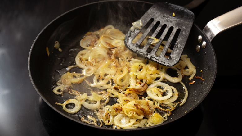 Onions are caramelized on the stove
