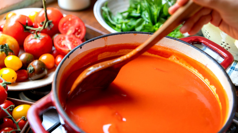 Tomato soup is cooked in a pot