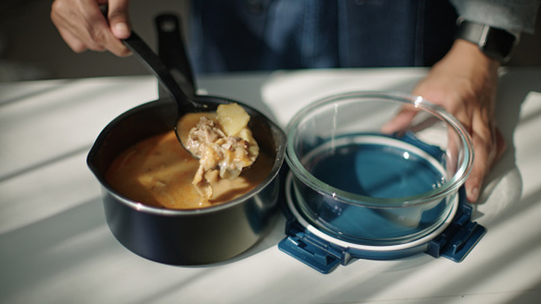 Soup is scooped into storage container
