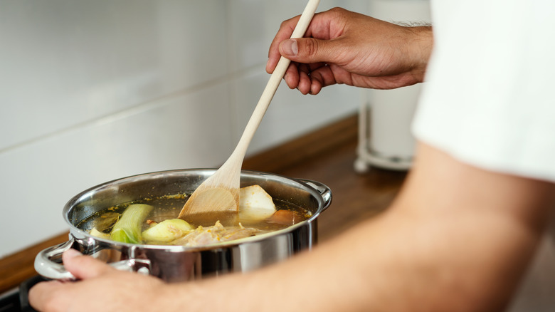 Vegetables are stirred into broth