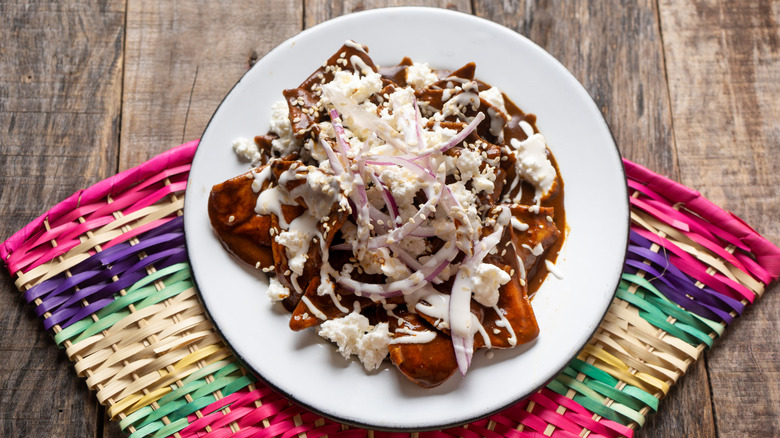 A plate of chilaquiles with mole sauce