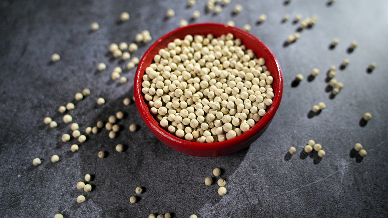 White peppercorns in a red bowl