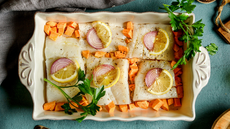 cod in dish with veggies and lemon