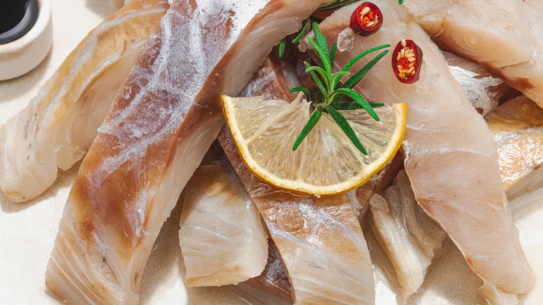 raw pollock slices on white background