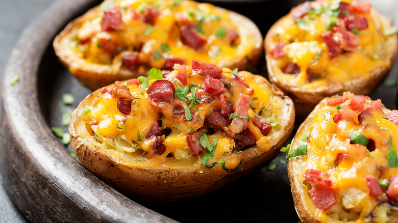Loaded potato skins topped with bacon, cheese, and fresh herbs