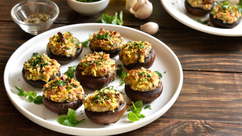 Mushrooms stuffed with cream cheese and scattered with fresh herbs