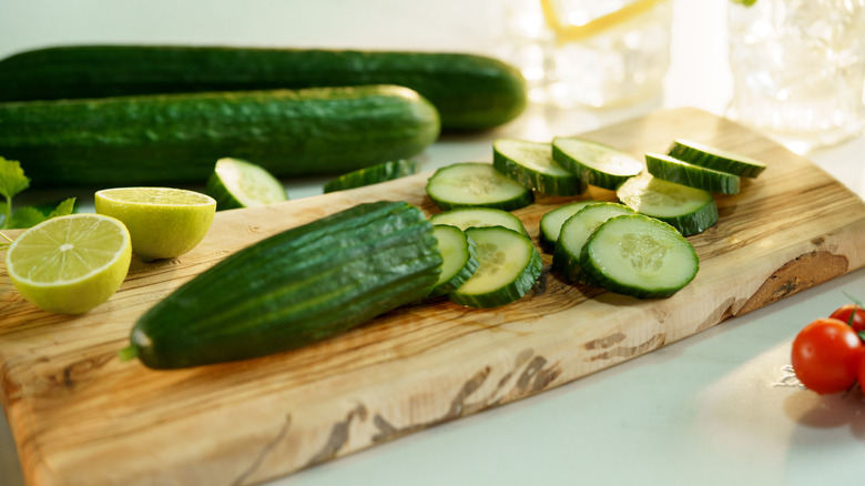 Sliced cucumber on wooden cutting board