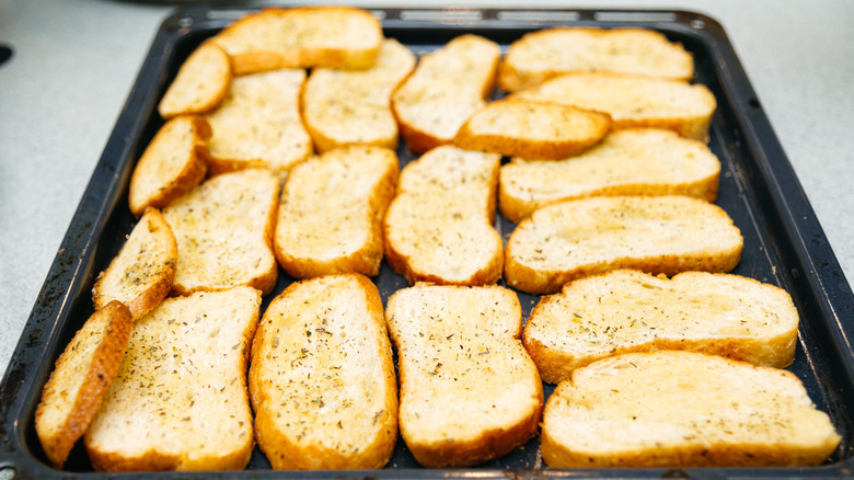Crostini slices on a baking tray
