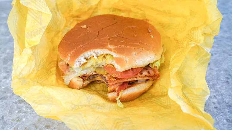 Close-up of Bacon & Cheese Whataburger on yellow wrapper