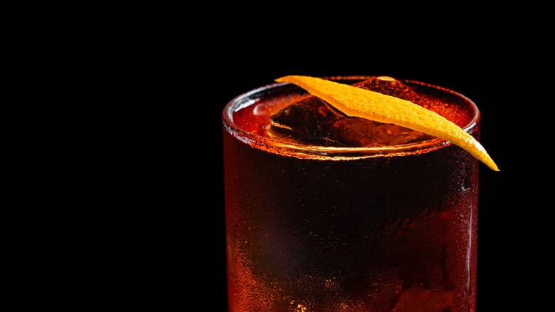 Boulevardier with orange peel on a black background