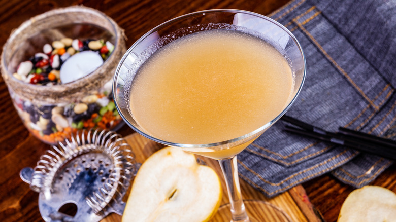 spiced pear martini with various bartending tools