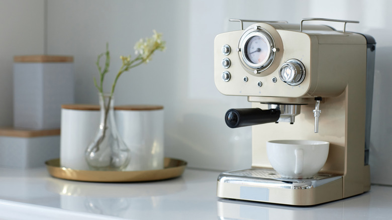 Espresso maker with cup on counter