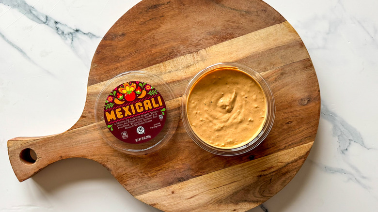 Mexicali dip on round, wooden cutting board