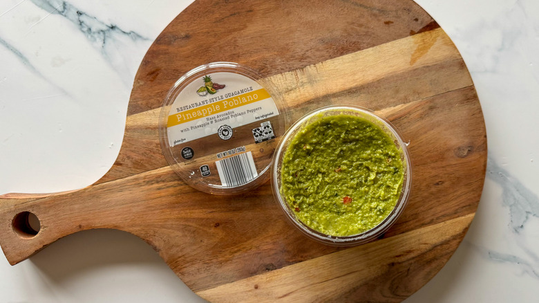 Pineapple Poblano Guacamole on round, wooden cutting board