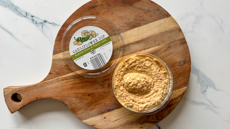 Roasted Chile and Pepper Jack Cauliflower Dip on round, wooden cutting board