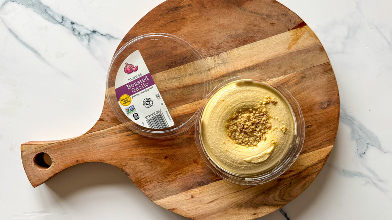 Roasted Garlic Hummus on round, wooden cutting board