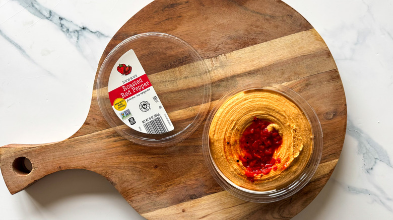 Roasted Red Pepper Hummus on round, wooden cutting board