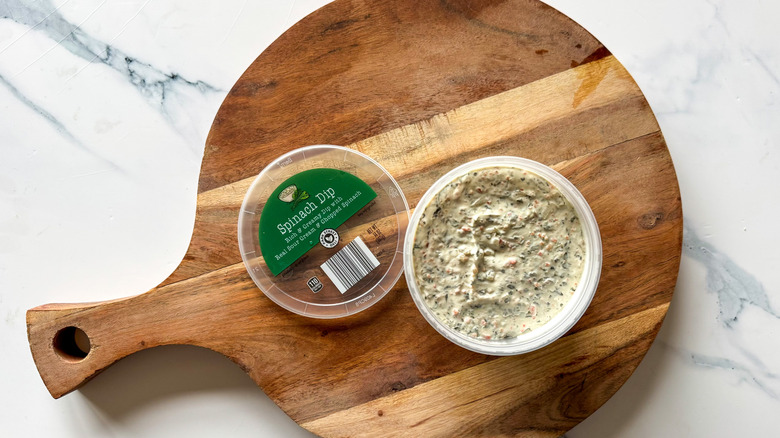 Spinach Dip on round, wooden cutting board