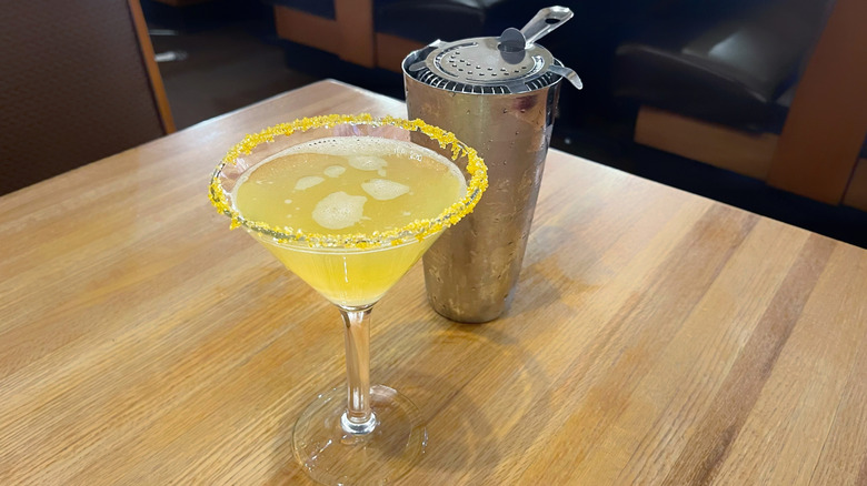 The Golden Goose from Applebee's in a martini glass alongside a cocktail shaker